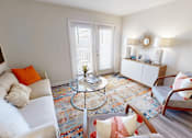 Thumbnail 4 of 27 - a living room with a couch and a table