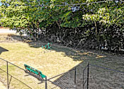 Thumbnail 20 of 27 - a park bench sitting in the grass next to a fence