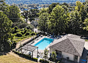 Thumbnail 19 of 27 - an aerial view of a swimming pool surrounded by buildings and trees