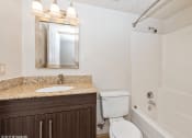 Thumbnail 9 of 13 - a bathroom with a toilet sink and shower and a mirror