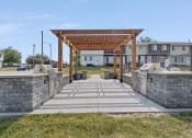 Thumbnail 23 of 34 - a stone walkway with a wooden pergola