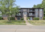 Thumbnail 6 of 34 - a large apartment building with a tree in front of it