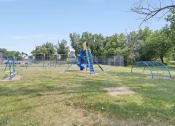 Thumbnail 24 of 34 - a playground with a swing set and monkey bars