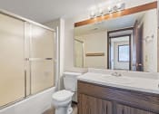 Thumbnail 11 of 34 - a bathroom with a sink toilet and shower