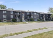 Thumbnail 28 of 34 - a large apartment building with a street in front of it