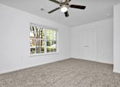 Thumbnail 10 of 33 - second bedroom with a ceiling fan and  carpet