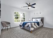 Thumbnail 7 of 33 - Apartment bedroom with a bed, window, and ceiling fan