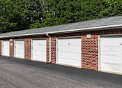 Thumbnail 25 of 33 - A row of white garage doors are closed.