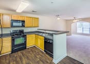 Thumbnail 3 of 33 - A kitchen with wood colored cabinets and dishwasher