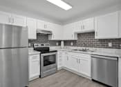 Thumbnail 2 of 33 - Apartment kitchen with cabinets and stainless steel appliances