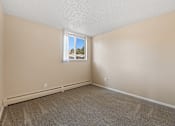 Thumbnail 8 of 20 - A room with a carpeted floor and a window.