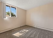 Thumbnail 7 of 20 - A room with a window and a carpet on the floor.