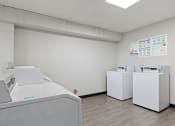 Thumbnail 9 of 18 - apartment complex laundry room with washes and dryers