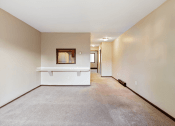 Thumbnail 7 of 18 - spacious apartmnt living room with white walls and carpeting