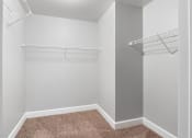 Thumbnail 6 of 16 - walk-in closet with two shelves in an apartment