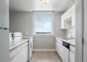 Thumbnail 2 of 16 - apartment kitchen with white appliances and a window
