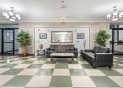 Thumbnail 10 of 16 - a lobby with couches and a coffee table on a checkered floor