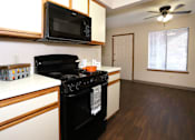 Thumbnail 4 of 23 - Apartment have oven and microwave at cross creek aprtments and townhomes