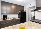 Thumbnail 2 of 22 - Apartment Kitchen with Granite Counters
