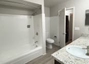 Thumbnail 13 of 18 - a bathroom with a bathtub and a sink