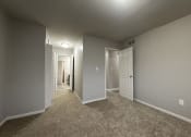 Thumbnail 12 of 18 - a bedroom with gray walls and carpet