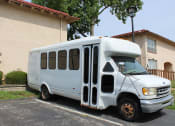 Thumbnail 24 of 31 - shuttle bus parked in a parking lot