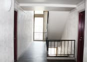Thumbnail 21 of 31 - a view down a flight of stairs with a window on one side and a railing on the