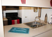 Thumbnail 8 of 31 - a kitchen with a sink and a stove