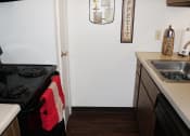 Thumbnail 7 of 31 - kitchen with a stove, refrigerator, and sink