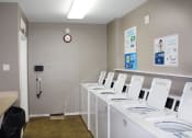 Thumbnail 19 of 31 - a laundry room with white washers