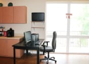 Thumbnail 16 of 31 - leasing office with a desk and a television