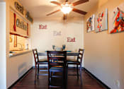 Thumbnail 7 of 36 - A dining room with a table and chairs.