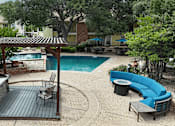 Thumbnail 21 of 30 - A backyard with a pool and a wooden deck.