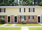 Thumbnail 17 of 17 - A row of houses with black front doors and windows.