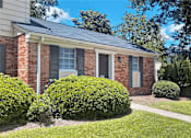 Thumbnail 13 of 17 - A house with a grey roof and a white garage door.