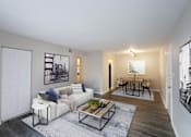 Thumbnail 1 of 11 - A living room with a white couch and a coffee table.