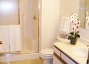 Thumbnail 12 of 19 - A white toilet sits next to a sink in a bathroom.