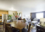 Thumbnail 7 of 19 - A dining room with a wooden table and chairs.