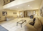 Thumbnail 18 of 19 - A living room with a couch, chairs, and a coffee table.