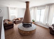 Thumbnail 19 of 32 - A living room with a fireplace and a couch.