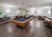 Thumbnail 17 of 32 - A room with a pool table and a billiard table.