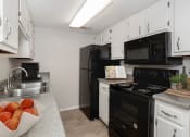 Thumbnail 1 of 15 - apartment with black kitchen appliances