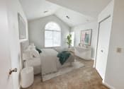 Thumbnail 7 of 31 - a bedroom with a bed and a bathtub