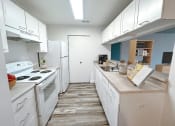 Thumbnail 4 of 31 - a kitchen with white appliances and white cabinets