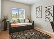 Thumbnail 6 of 24 - A bedroom with a large bed and two framed artworks on the wall.