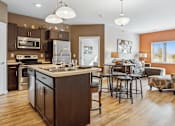 Thumbnail 2 of 24 - A kitchen with a large island and a dining area.