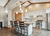 Thumbnail 3 of 24 - A kitchen with a white counter and stainless steel appliances.