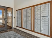 Thumbnail 12 of 24 - A row of mailboxes are lined up on a wall.
