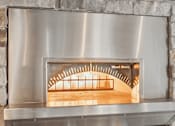 Thumbnail 13 of 24 - A wood stove with a metal frame and a glass door.