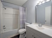 Thumbnail 4 of 12 - a bathroom with a shower toilet and sink